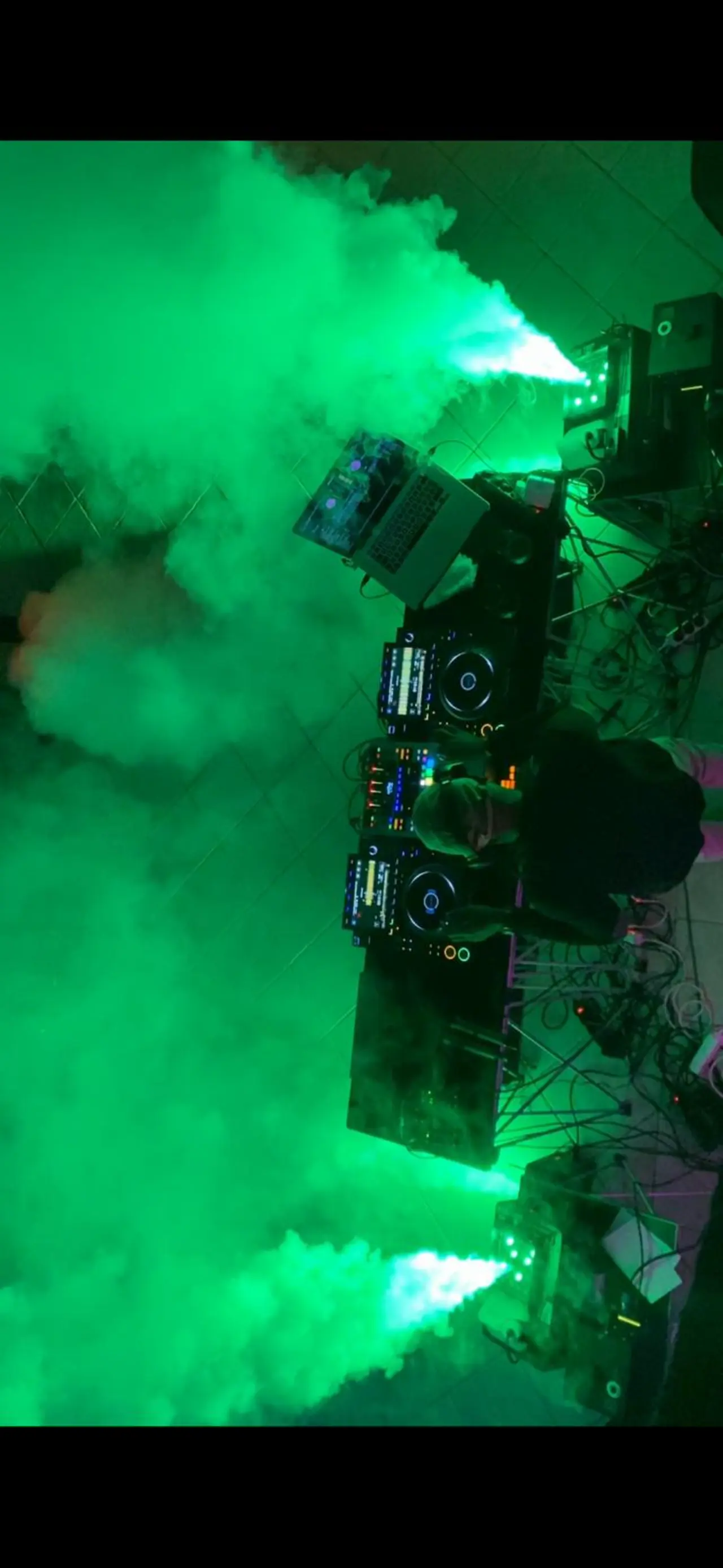 DJ playing in a smoke.